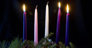 Advent calendar with three lit candles
