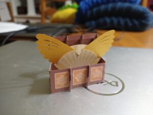 Papercraft model of a wooden chest with wings