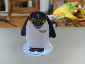 A papercraft penguin wearing goggles