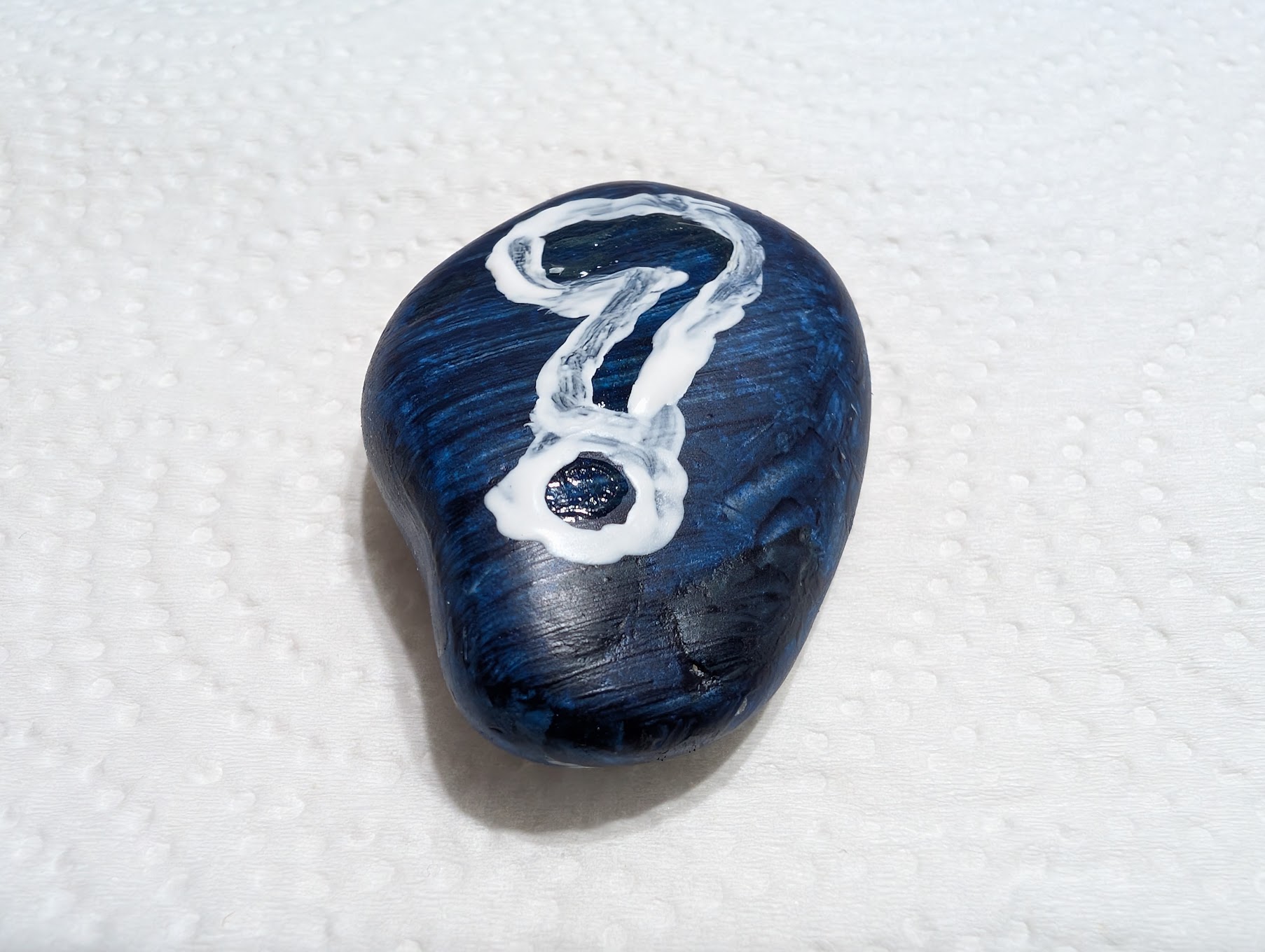 rock with question mark painted on it