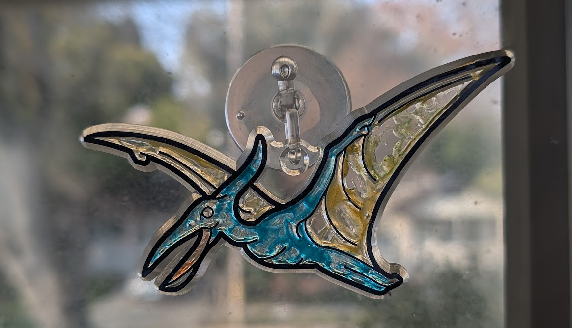 Stained glass pterodactyl hanging in the window