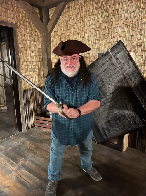 A picture of Richard in a pirate hat and wielding a sword.